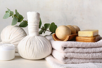 Spa composition with eucalyptus branch on light wooden table, closeup