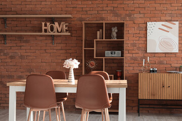 Interior of loft style living room with table, chairs and shelving unit
