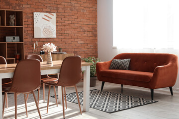 Living room in loft style with sofa, table and chairs