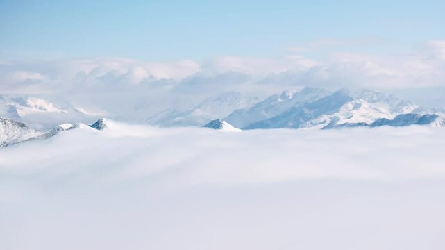 aerial view timelapse of winter snow mountain landscape with clouds mist moving