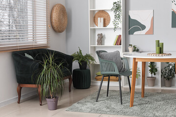 Modern living room with black sofa, table and shelving unit