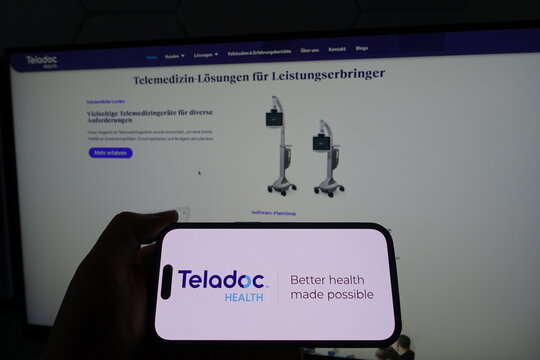 Kiel, SH, Germany March 19 2025: Smartphone with the logo of Teladoc Health in front of a monitor displaying their business website featuring telemedicine solutions
