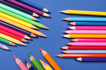 Set of colorful pencils on blue background