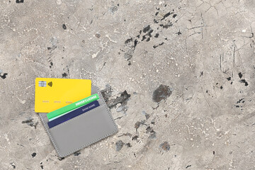 Grey holder with credit cards and driver's license on grey grunge background