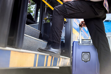Low Angle Of Unrecognized Person With Luggage Getting Into The Bus