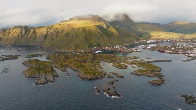 Panoramic drone shot of Ballstad fishing village in Lofoten islands, Norway during sunrise