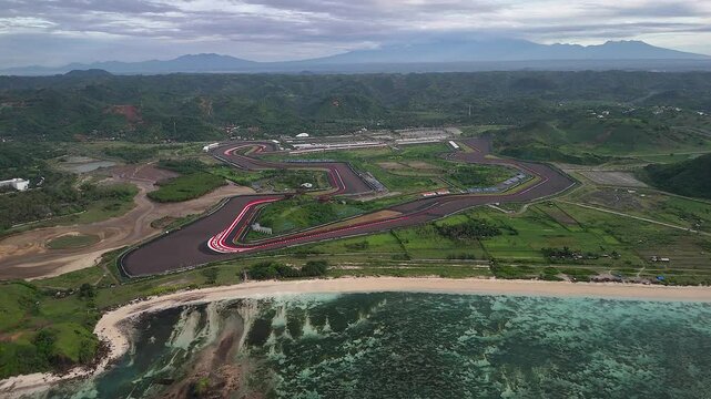 Aerial pulls out: International moto race track on flat Lombok coast
