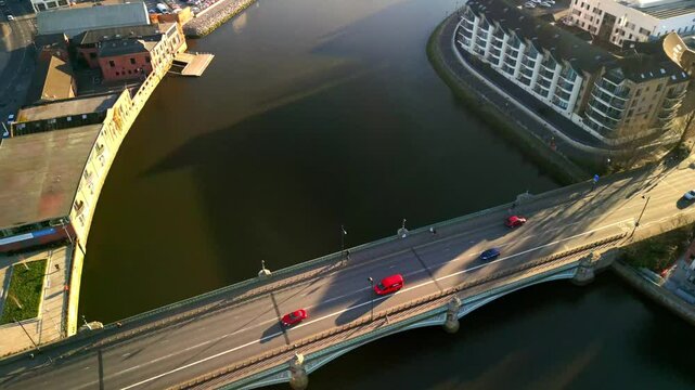 Ascending aerial of Queen's Bridge and the River Lagan in Belfast, Northern Ireland on a sunny day. Filmed in 4K, 60FPS with Rec709 color.