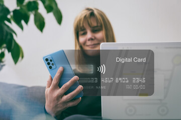 Woman makes online purchase using a digital card on laptop. Convenience and ease of e-commerce. Secure web shopping, digital payments and modern retail technology. E-commerce, digital transactions.