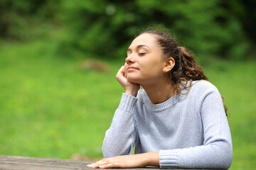 Woman relaxing with closed eyes in nature