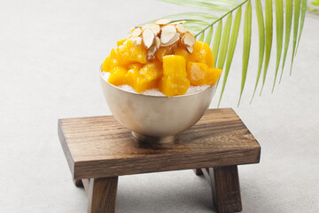Patbingsu is a food made by crushing ice into small pieces and adding boiled red beans or sugar.