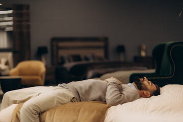 Man Relaxing on a Comfortable Bed in a Stylish Interior Setting