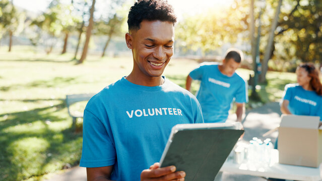 Nature, man and volunteer with tablet for research on food drive donation list for organization. Reading, outdoor and male NGO worker with digital technology in park for nonprofit or charity event. - Powered by Adobe