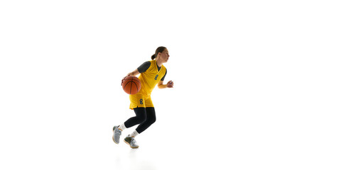 Side view of competitive woman in yellow jersey and black shorts in motion with ball, playing isolated on white background. Concept of sport, competition, game, action, active lifestyle. Ads