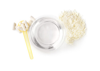 Glass of water with plastic scoop, collagen powder and pills on white background