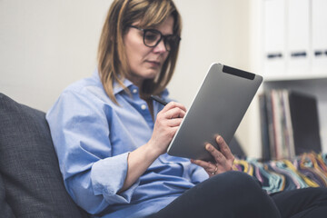 Woman uses stylus on tablet. Girl write with digital pen on device. Modern and efficient workflow