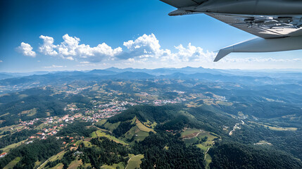 Aerial View Of Lush Green Valley And Cityscape With Blue Sky
