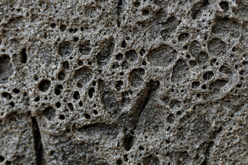 Old stone wall texture with rough, gray, and weathered surface detail