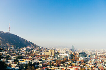 Top view of a large city in a gorge. Megapolis in the mountains. Top view of many buildings. Georgia. Tbilisi