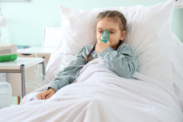 Ill little girl with nebulizer in clinic