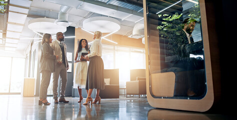 Lobby, pod and business people in office for coworking space for collaboration, teamwork or discussion. Professional, corporate and men and women talking with cubicle for meeting in private workspace