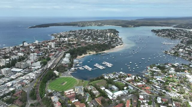 slow drone pan coastline cronulla marina with sport oval