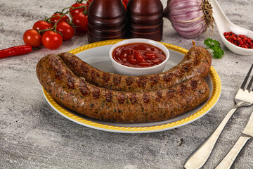Grilled beef sausages with sauce