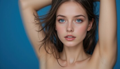 Obraz premium Portrait of Young Woman with Blue Eyes and Hands Behind Head