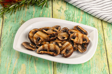 Tasty hot grilled champignon mushrooms