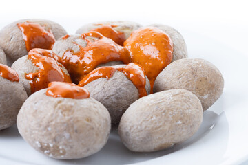 Papas arrugadas with mojo isolated on white background. Traditional Canarian food