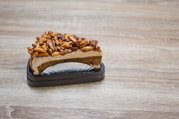 Caramel Almond Toffee Cake. Brown needle coffee cake in a separate container on a wooden table