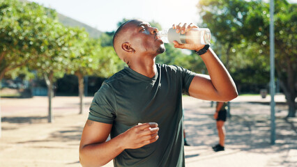 Fitness, man and drinking water outdoor for health, body wellness and exercise recovery. Bottle,...
