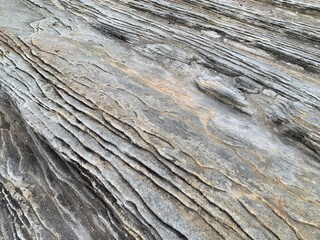 Full frame of sandstone rock pattern, Rock formation, natural of sand stone on beach in Australia, line and curve of stone use for background	