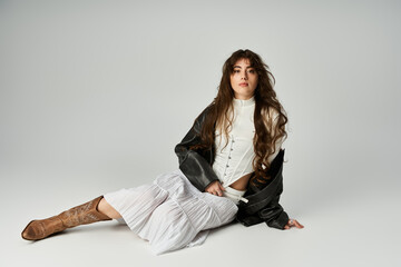 Stylish young woman showcases trendy fashion on a simple backdrop in a playful and artistic way