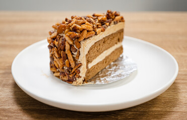 Caramel Almond Toffee Cake. Brown needle coffee cake in a separate container on a wooden table