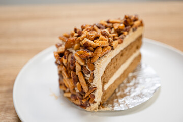 Caramel Almond Toffee Cake. Brown needle coffee cake in a separate container on a wooden table