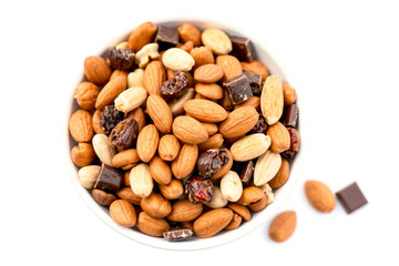 Fototapeta premium Healthy trail mix image featuring almonds, peanuts, raisins, and chocolate candies, fast-food image isolated white background