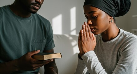 Fototapeta premium Faithful Devotion: Black Christian Couple Praying on Their Knees in a Bright Room