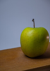 green apple on a wooden table