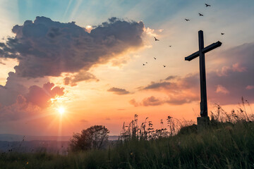 Easter Religious concept: The cross on meadow autumn sunrise background. Symbol of Faith and Hope