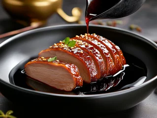 Ingelijste posters Peking Chef pouring peking duck sauce on sliced duck breast in black plate  © Atlantis
