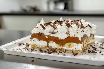 Banoffee Pie (UK) A rich banoffee pie with a visible cross-section showcasing layers of banana slices