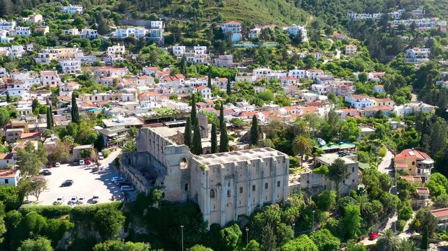 Aerial view of Bellapais Abbey, a historical monastery in Cyprus, showcasing its stunning architecture amidst a charming village