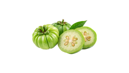 Close up of green garcinia cambogia fruits with leaf and sliced halves on a black background