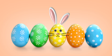 Bright Easter eggs on peach color background, banner design. Yellow one with bunny ears and face