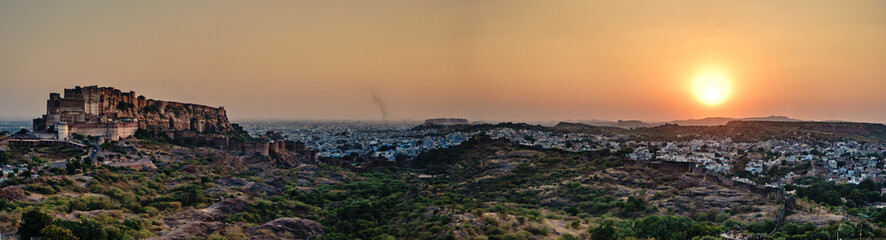 India. State of Rajasthan. Jodhpur. Panoramic view of Mehrangarh Fort (historic stronghold of the Rathore Rajput royal rulers). Outer walls and ramparts in a golden late afternoon light