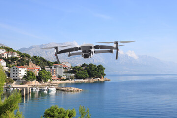 Drone with camera flying near city. Unmanned aerial vehicle for surveillance