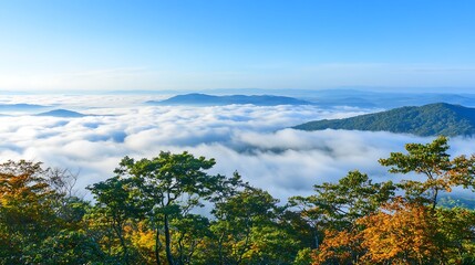 Naklejka premium The picturesque view of mountainous terrain covered by clouds and sky