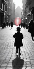 Obraz premium Alone child walking down city street with red balloon. Loneliness