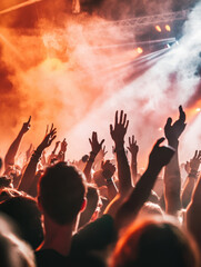 A crowd at a rock music festival with hands raised and energy bursting from the audience